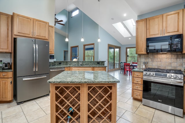 1355 W Buell Rd, Oakland, MI 48363 - kitchen with stainless steel appliances, a skylight, a sink, high vaulted ceiling, and light tile patterned flooring