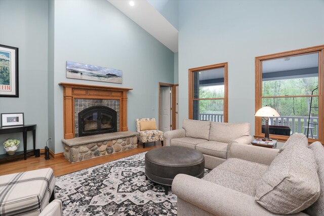 1355 W Buell Rd, Oakland, MI 48363 - living room with wood finished floors, a towering ceiling, a glass covered fireplace, and baseboards