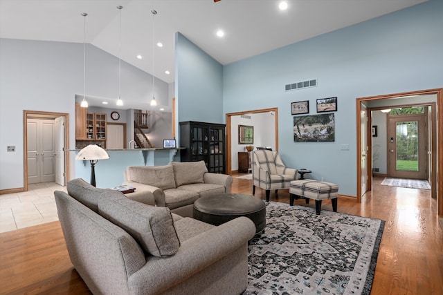 1355 W Buell Rd, Oakland, MI 48363 - living room featuring high vaulted ceiling, baseboards, light wood-style flooring, and recessed lighting
