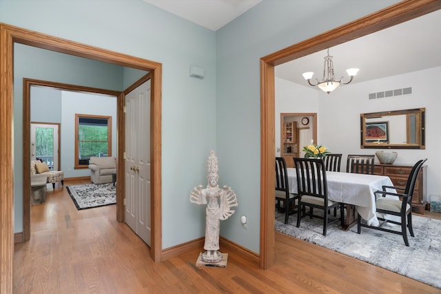 1355 W Buell Rd, Oakland, MI 48363 - hall with wood finished floors, a chandelier, and baseboards