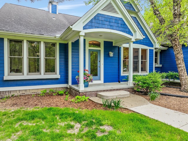 1355 W Buell Rd, Oakland, MI 48363 - entrance to property with a porch, a shingled roof, and a chimney