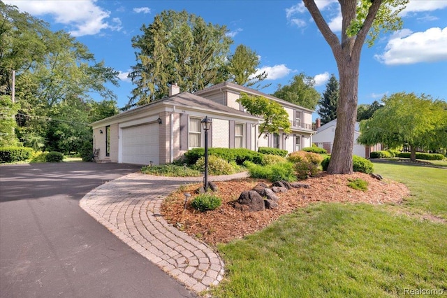 5116 Mohr Valley Ln, Bloomfield Hills, MI 48304 - view of front of house featuring a chimney, an attached garage, a front yard, driveway, and brick siding