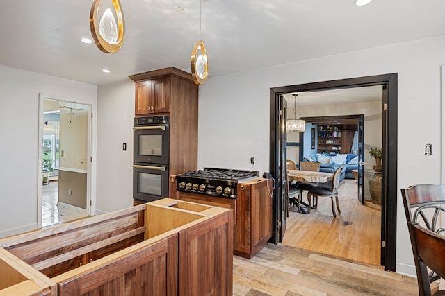 14240 Rosemont Ave, Detroit, MI 48223 - kitchen with black appliances, a chandelier, light wood-style flooring, pendant lighting, and recessed lighting