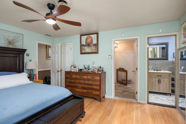 14240 Rosemont Ave, Detroit, MI 48223 - bedroom with light wood finished floors, ensuite bath, a ceiling fan, and a closet