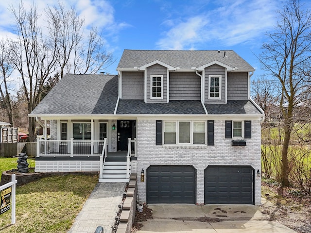 576 E Flint St, Lake Orion, MI 48362 - view of front of property with a garage, driveway, a porch, a front lawn, and brick siding