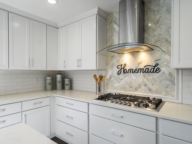 576 E Flint St, Lake Orion, MI 48362 - kitchen featuring wall chimney range hood, stainless steel gas stovetop, tasteful backsplash, white cabinetry, and light stone countertops