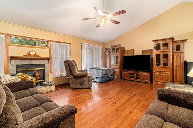 1658 Ridgeview Ct, Ludington, MI 49431 - living area with ceiling fan, light wood-style floors, a fireplace, and high vaulted ceiling