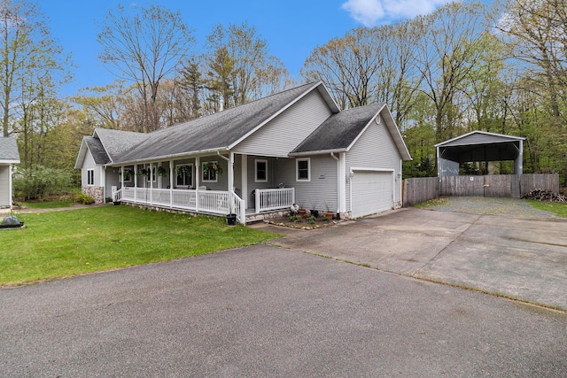 1658 Ridgeview Ct, Ludington, MI 49431 - view of front of property with a porch, driveway, a garage, a detached carport, and roof with shingles
