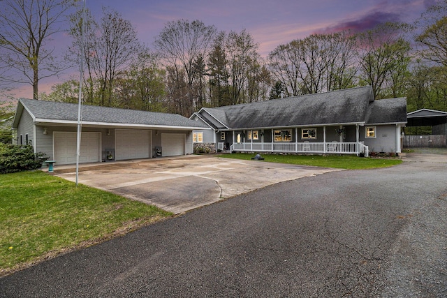 1658 Ridgeview Ct, Ludington, MI 49431 - ranch-style house with a porch, a front yard, driveway, and a garage