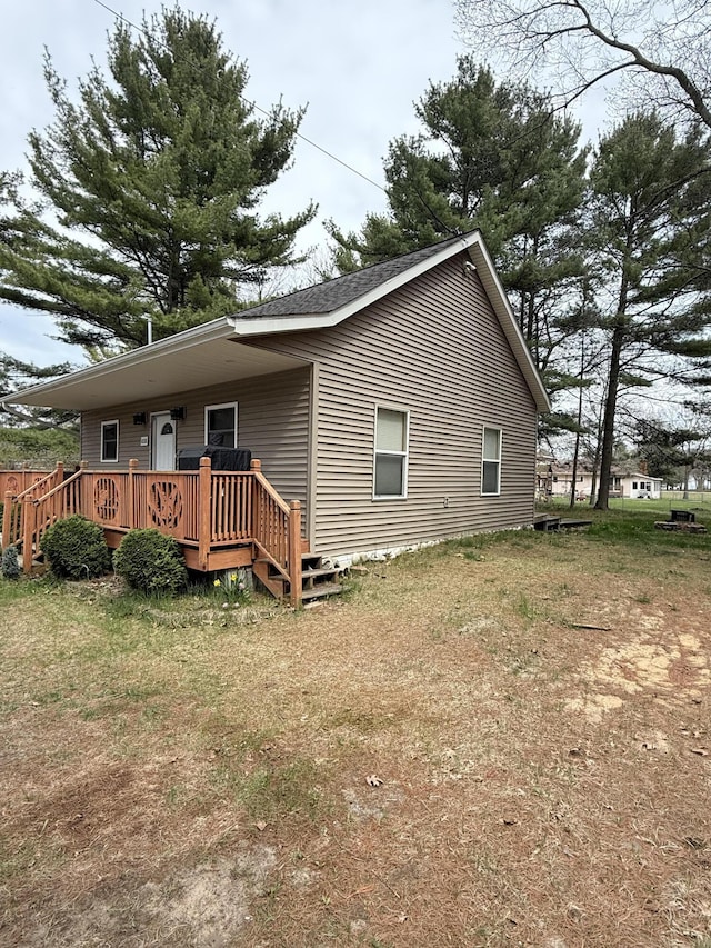 rear view of house featuring a deck