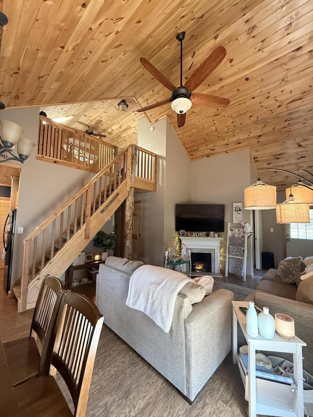 1038 Wintergreen St, East Tawas, MI 48730 - living area with wood ceiling, stairway, ceiling fan, a fireplace, and wood finished floors
