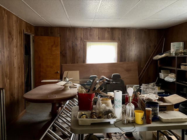 dining area featuring wood walls