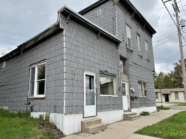 view of side of home featuring entry steps