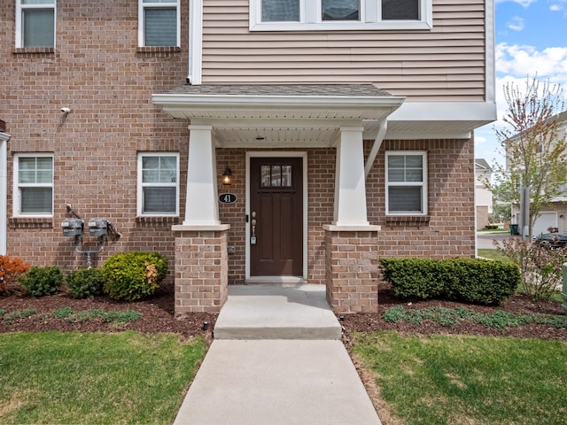 view of exterior entry with brick siding