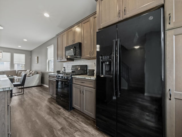 kitchen with black appliances, baseboards, open floor plan, decorative backsplash, and dark wood-style flooring