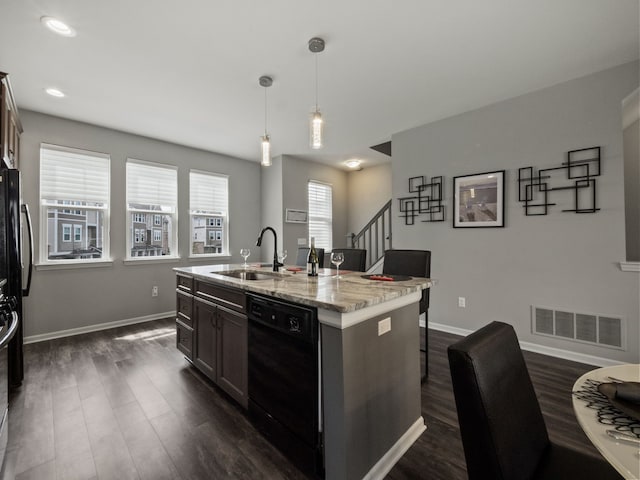 kitchen with black dishwasher, a breakfast bar, a sink, dark wood-style floors, and baseboards