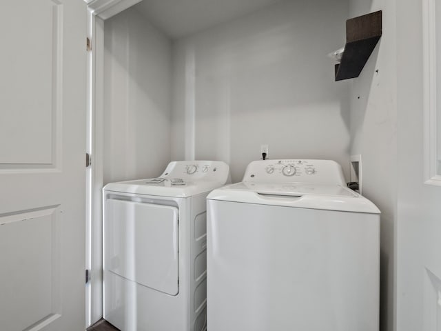 clothes washing area with separate washer and dryer