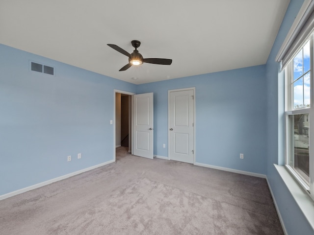 unfurnished bedroom with carpet, baseboards, and a ceiling fan
