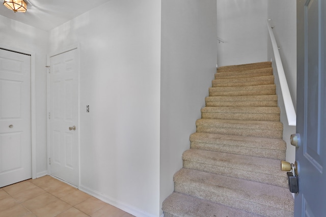 stairs featuring tile patterned floors