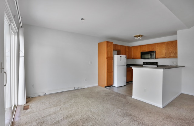 kitchen with freestanding refrigerator, black microwave, stove, carpet, and dark countertops