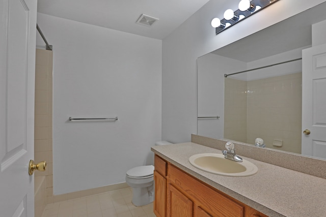 bathroom featuring toilet, vanity, tile patterned floors, bathtub / shower combination, and baseboards