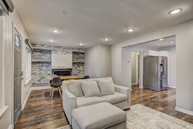 living area with dark wood finished floors, a fireplace, recessed lighting, and baseboards