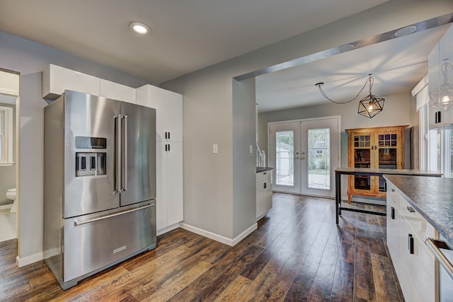 kitchen featuring high end refrigerator, french doors, dark wood finished floors, baseboards, and recessed lighting