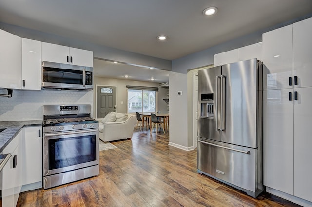kitchen featuring stainless steel appliances, dark wood-style flooring, white cabinetry, and recessed lighting