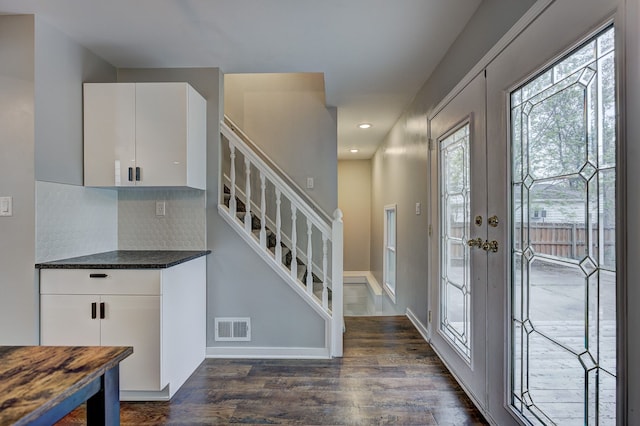foyer featuring dark wood finished floors, stairway, recessed lighting, and baseboards