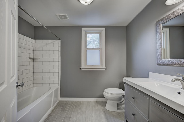 full bathroom featuring baseboards, toilet, vanity, and shower / bathtub combination