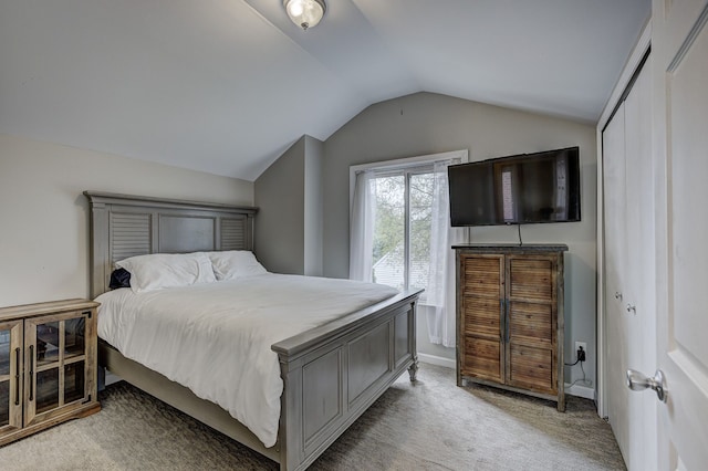 bedroom featuring vaulted ceiling and light colored carpet
