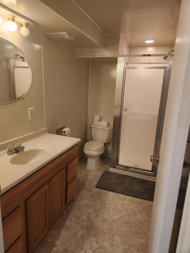 bathroom featuring a stall shower, toilet, and vanity