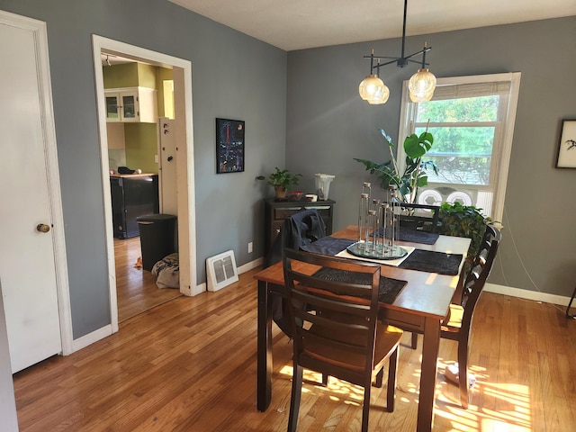 dining space with wood finished floors and baseboards