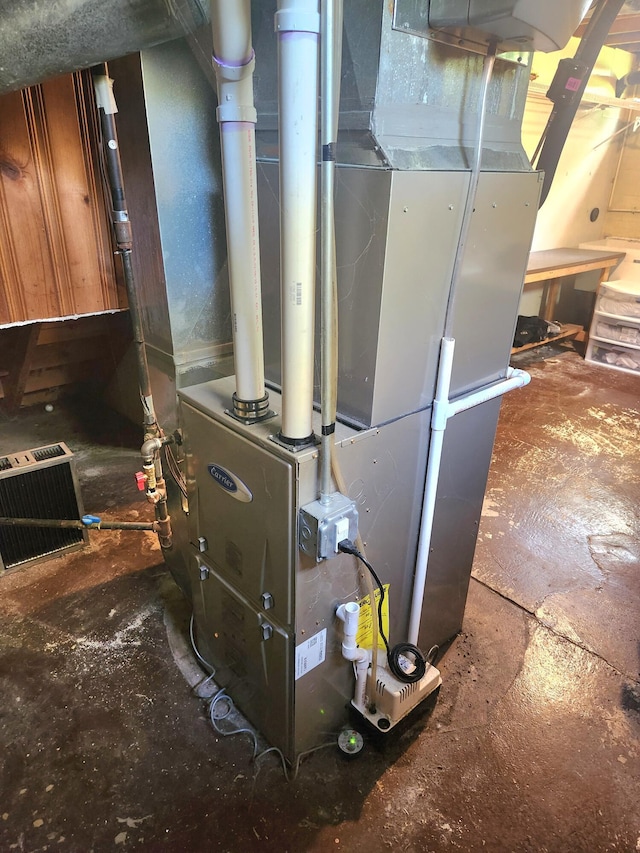 utility room featuring heating unit