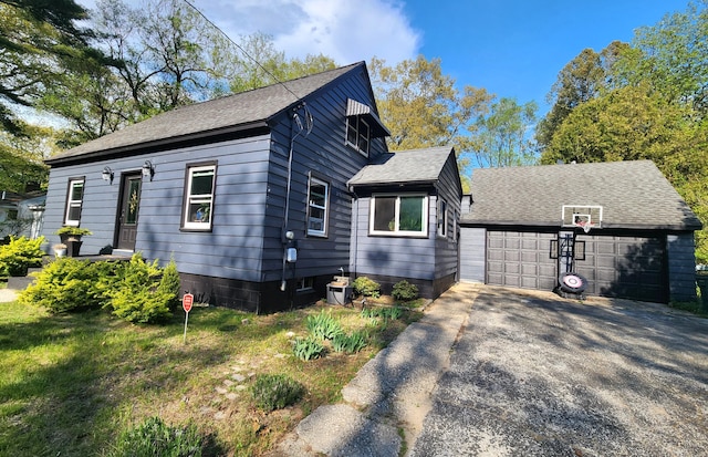 view of front of house with an outdoor structure and a shingled roof