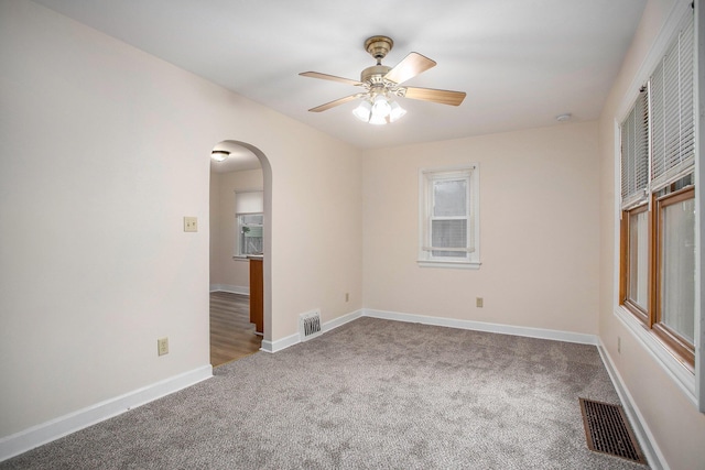 8 Vernon Ave, Battle Creek, MI 49014 - unfurnished room with arched walkways, carpet, ceiling fan, and baseboards