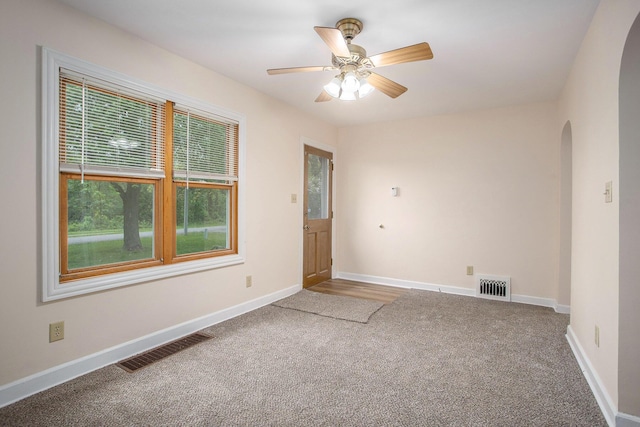 8 Vernon Ave, Battle Creek, MI 49014 - carpeted spare room with arched walkways, baseboards, and ceiling fan