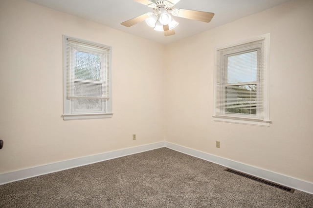 8 Vernon Ave, Battle Creek, MI 49014 - spare room with dark colored carpet, baseboards, and ceiling fan