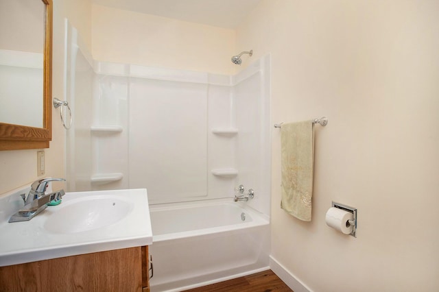 8 Vernon Ave, Battle Creek, MI 49014 - bathroom featuring wood finished floors, baseboards, vanity, and bathtub / shower combination