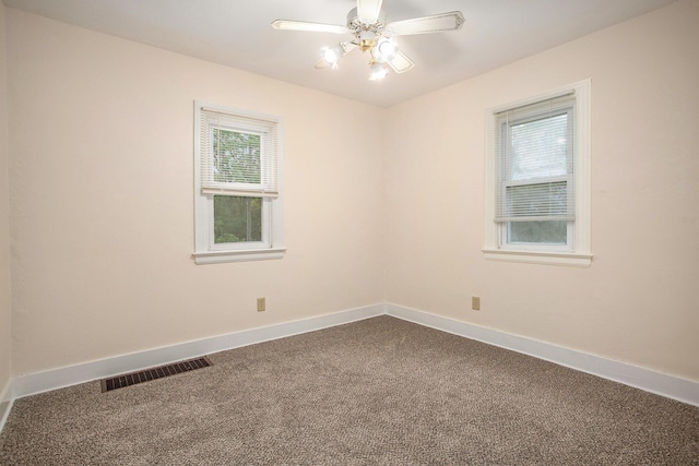 8 Vernon Ave, Battle Creek, MI 49014 - spare room with dark carpet, baseboards, and ceiling fan