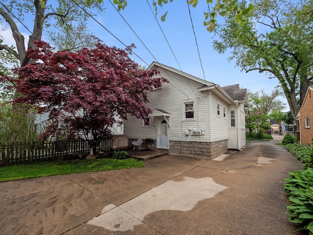 view of property exterior with concrete driveway
