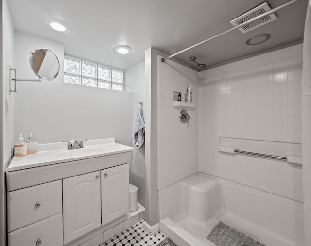 bathroom featuring a shower, vanity, and tile patterned flooring