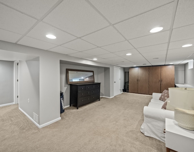 sitting room with light colored carpet, recessed lighting, and baseboards