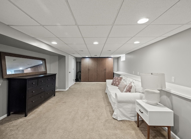 living area with light carpet, recessed lighting, a paneled ceiling, and baseboards