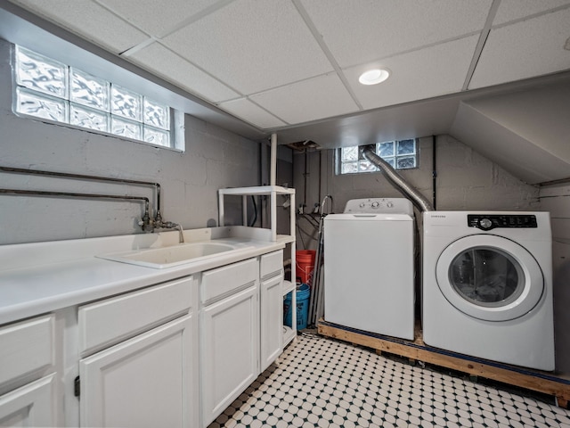 laundry area with washing machine and dryer, cabinet space, and light floors