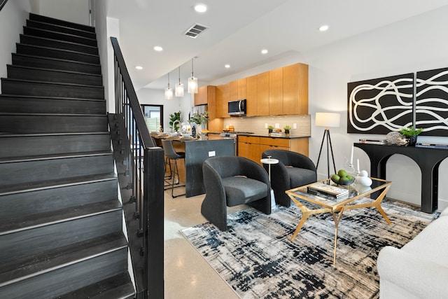 5234 Avery St, Detroit, MI 48208 - living room featuring stairway, recessed lighting, and dark aggregate flooring