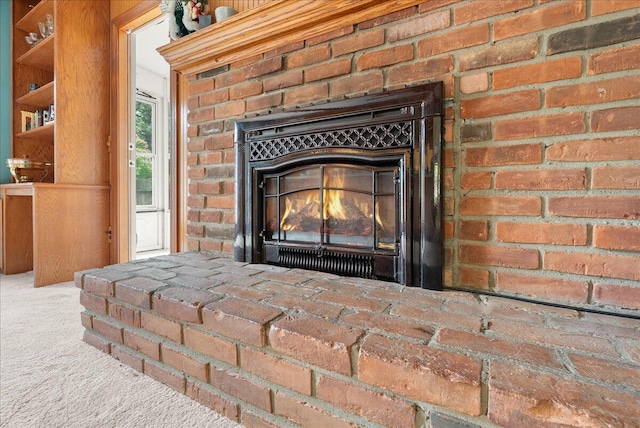 2020 NW Ave, Lansing, MI 48906 - detailed view of a brick fireplace and carpet flooring
