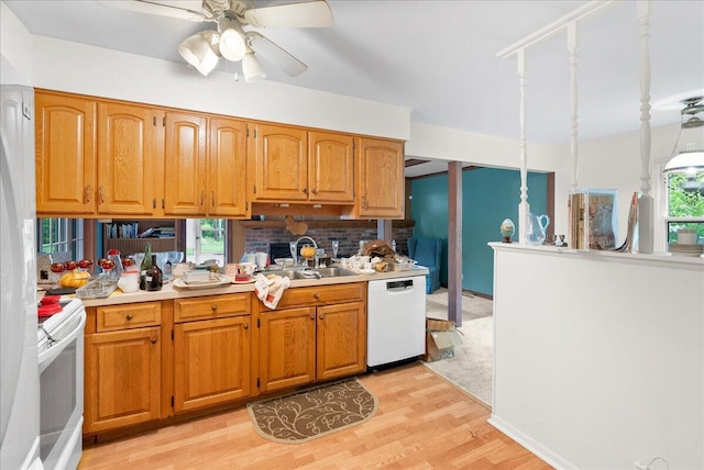 2020 NW Ave, Lansing, MI 48906 - kitchen featuring white appliances, a sink, light wood finished floors, a ceiling fan, and light countertops