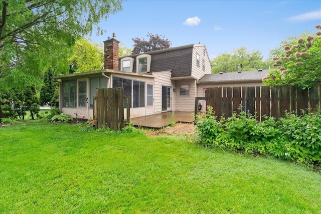 2020 NW Ave, Lansing, MI 48906 - back of property with a chimney, a sunroom, and roof with shingles