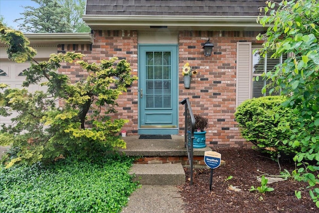 2020 NW Ave, Lansing, MI 48906 - doorway to property with roof with shingles and brick siding